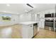 Eat-in kitchen with island, stainless appliances, and hardwood floors at 4220 E Regnas Ave, Tampa, FL 33617