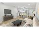 Modern living room design with open floor plan, barstool seating, and decorative furnishings at 4220 E Regnas Ave, Tampa, FL 33617
