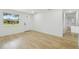 Bright living room featuring hardwood floors, a large window, and white walls at 4220 E Regnas Ave, Tampa, FL 33617