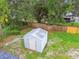 Aerial view of backyard featuring a metal shed with mature landscaping at 4220 E Regnas Ave, Tampa, FL 33617