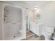 Bright bathroom with a white vanity and toilet, plus a large shower with seating and modern fixtures at 4503 Jacona Dr, Hernando Beach, FL 34607