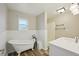 Bright bathroom featuring a clawfoot tub, a walk-in shower, and modern fixtures throughout the space at 4503 Jacona Dr, Hernando Beach, FL 34607