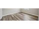 Corner view of a bright bedroom with gray walls, white trim, and wood-look floors throughout the room at 4503 Jacona Dr, Hernando Beach, FL 34607