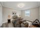 Bright staged bedroom with a large window offering a view of the neighborhood and natural-colored decor at 4503 Jacona Dr, Hernando Beach, FL 34607