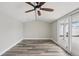 Bright bonus room featuring wood-look floors, modern ceiling fan, and sliding glass doors to the outside at 4503 Jacona Dr, Hernando Beach, FL 34607