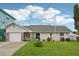 Charming single Gathering home boasts a manicured lawn and stone accents at 4503 Jacona Dr, Hernando Beach, FL 34607