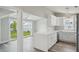 Modern kitchen with white cabinets, a farmhouse sink, and a view of the backyard at 4503 Jacona Dr, Hernando Beach, FL 34607