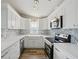 Bright kitchen features white cabinets, stone countertops, stainless steel appliances, and modern backsplash at 4503 Jacona Dr, Hernando Beach, FL 34607