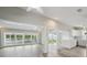 Open-concept living room with hardwood floors, great lighting, and an adjacent kitchen at 4503 Jacona Dr, Hernando Beach, FL 34607