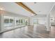 Bright, open living room with ceiling fan and sliding glass doors to the pool and dining area at 4503 Jacona Dr, Hernando Beach, FL 34607