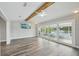 Bright, open living room with ceiling fan and sliding glass doors to the pool area at 4503 Jacona Dr, Hernando Beach, FL 34607