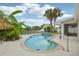 Backyard swimming pool surrounded by lush greenery and a tiki hut at 4503 Jacona Dr, Hernando Beach, FL 34607
