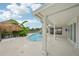 Backyard swimming pool surrounded by white columns and a tiki hut at 4503 Jacona Dr, Hernando Beach, FL 34607