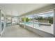Bright sunroom overlooking a pool with a jacuzzi and canal views beyond at 4503 Jacona Dr, Hernando Beach, FL 34607