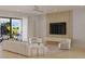 Comfortable living room with a wall mounted TV and access to a balcony with outdoor seating at 4535 26Th S Ave, St Petersburg, FL 33711