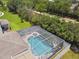 Stunning aerial view of the property showcasing the screened-in pool and backyard with mature trees at 4544 Vermillion Sky Dr, Wesley Chapel, FL 33544