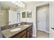 Bathroom featuring double vanity with granite counters, and a walk-in shower at 4544 Vermillion Sky Dr, Wesley Chapel, FL 33544