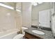 Bathroom featuring granite countertop, tiled shower-tub combo, toilet and large mirror at 4544 Vermillion Sky Dr, Wesley Chapel, FL 33544