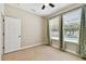 Bright bedroom with tile floors, ceiling fan and windows overlooking the pool area at 4544 Vermillion Sky Dr, Wesley Chapel, FL 33544
