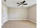 Bedroom features tile floors, ceiling fan, and white door at 4544 Vermillion Sky Dr, Wesley Chapel, FL 33544