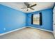 Blue bedroom with a ceiling fan, a window, and tile floors at 4544 Vermillion Sky Dr, Wesley Chapel, FL 33544