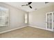 Neutral bedroom featuring tile floors, a ceiling fan, and windows for natural light and ventilation at 4544 Vermillion Sky Dr, Wesley Chapel, FL 33544