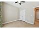 Spacious bedroom featuring tile flooring, ceiling fan, closet, and neutral-colored walls at 4544 Vermillion Sky Dr, Wesley Chapel, FL 33544