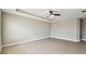 Large bedroom with a tray ceiling, tile floors, neutral paint, and a single window at 4544 Vermillion Sky Dr, Wesley Chapel, FL 33544