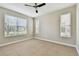 Well-lit bedroom with neutral walls, tile flooring, and multiple windows offering a serene view at 4544 Vermillion Sky Dr, Wesley Chapel, FL 33544