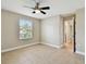 Spacious bedroom with tile floors, a large window, and access to bathroom at 4544 Vermillion Sky Dr, Wesley Chapel, FL 33544