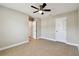 Bedroom with tile floors, ceiling fan, and white doors at 4544 Vermillion Sky Dr, Wesley Chapel, FL 33544