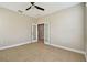 Spacious bedroom featuring tile floors, neutral walls, a ceiling fan, and a french door entrance at 4544 Vermillion Sky Dr, Wesley Chapel, FL 33544