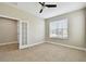 Bright bedroom featuring tiled floor, a ceiling fan, and a large window for natural light at 4544 Vermillion Sky Dr, Wesley Chapel, FL 33544