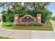 Community entrance sign surrounded by lush landscaping and brick columns at 4544 Vermillion Sky Dr, Wesley Chapel, FL 33544
