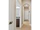 Inviting hallway with archways leading to rooms, featuring neutral tones and a glimpse of a bathroom at 4544 Vermillion Sky Dr, Wesley Chapel, FL 33544