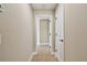 Hallway featuring neutral paint, tile flooring, and access to rooms at 4544 Vermillion Sky Dr, Wesley Chapel, FL 33544