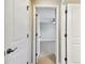 Hallway with white doors leading to carpeted rooms and a view of the loft area at 4544 Vermillion Sky Dr, Wesley Chapel, FL 33544