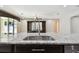 Close-up of granite countertop and sink in the kitchen, overlooking the open-plan living area at 4544 Vermillion Sky Dr, Wesley Chapel, FL 33544