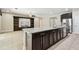 Modern kitchen island with stainless steel dishwasher, granite countertops, and built-in shelving unit at 4544 Vermillion Sky Dr, Wesley Chapel, FL 33544