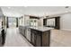 Kitchen island with granite countertop open to the living room and stainless steel dishwasher at 4544 Vermillion Sky Dr, Wesley Chapel, FL 33544