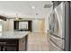 View of kitchen featuring a granite countertop, stainless steel refrigerator, and built-in shelving unit at 4544 Vermillion Sky Dr, Wesley Chapel, FL 33544