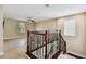 Upstairs landing with decorative wrought iron railing, tile flooring, and a ceiling fan at 4544 Vermillion Sky Dr, Wesley Chapel, FL 33544