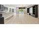 Open-concept living room with tile flooring, custom built-ins, and sliding glass doors to the pool area at 4544 Vermillion Sky Dr, Wesley Chapel, FL 33544