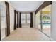 Living room with tile floors, sliding doors leading to the pool, and large windows at 4544 Vermillion Sky Dr, Wesley Chapel, FL 33544