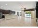 Expansive open-concept living space with tile flooring and direct access to the pool area through sliding glass doors at 4544 Vermillion Sky Dr, Wesley Chapel, FL 33544