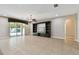 Spacious living room with tile floors, ceiling fan and sliding glass doors to the outdoor pool area at 4544 Vermillion Sky Dr, Wesley Chapel, FL 33544