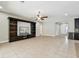 Open floor plan living room with decorative built-in shelving and easy access to other living spaces at 4544 Vermillion Sky Dr, Wesley Chapel, FL 33544