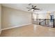 Upstairs loft area with tile flooring, ceiling fan, neutral paint, and wrought iron railing at 4544 Vermillion Sky Dr, Wesley Chapel, FL 33544