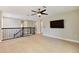 Spacious loft area with ceiling fan, mounted TV and tile flooring at 4544 Vermillion Sky Dr, Wesley Chapel, FL 33544