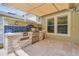 Entertain in style with this outdoor kitchen featuring a built-in grill, countertop space, and elegant stone accents at 4544 Vermillion Sky Dr, Wesley Chapel, FL 33544